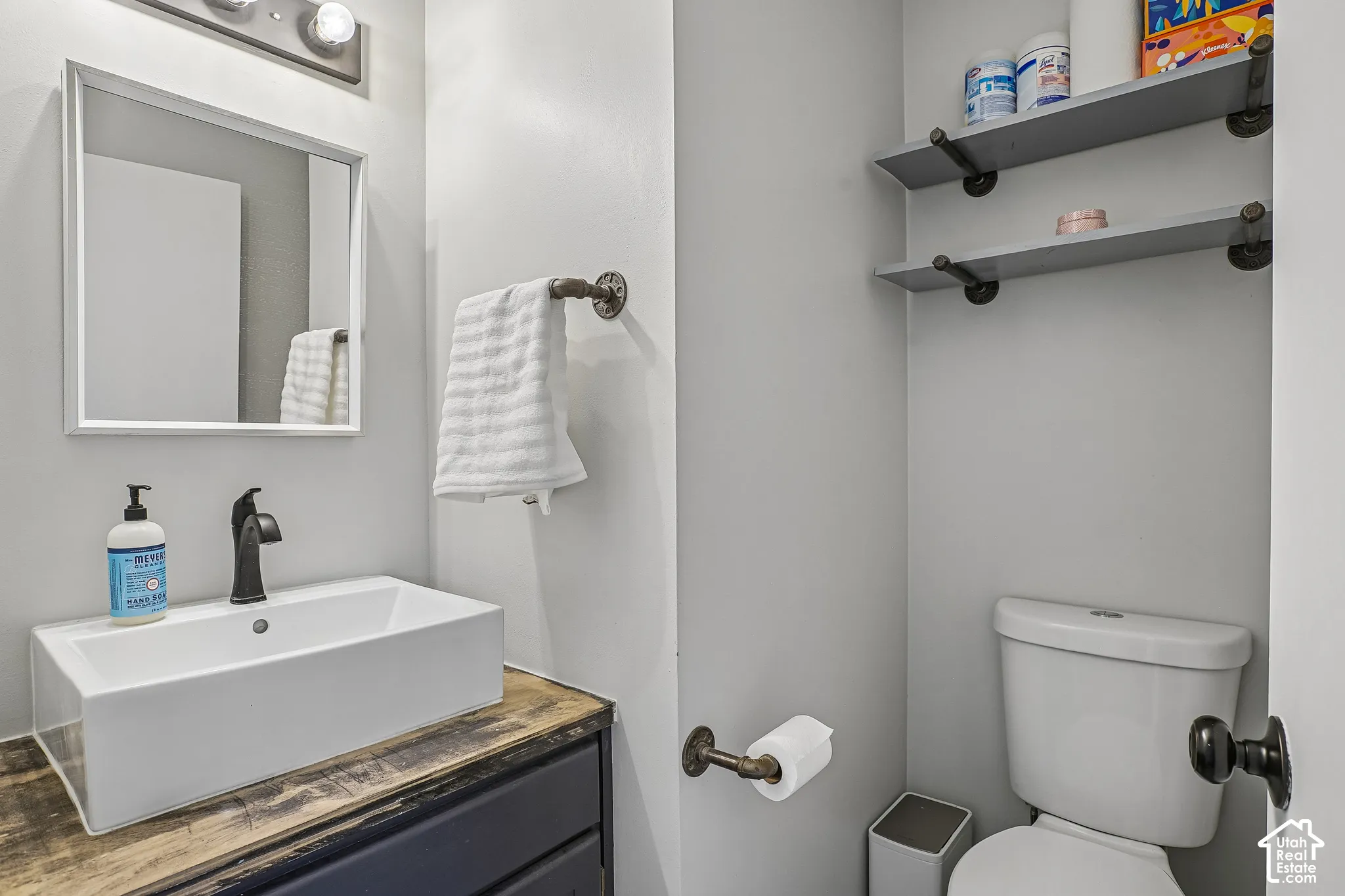 Modern rectangular vessel sink with a matte black faucet, set on a wood-finish vanity countertop