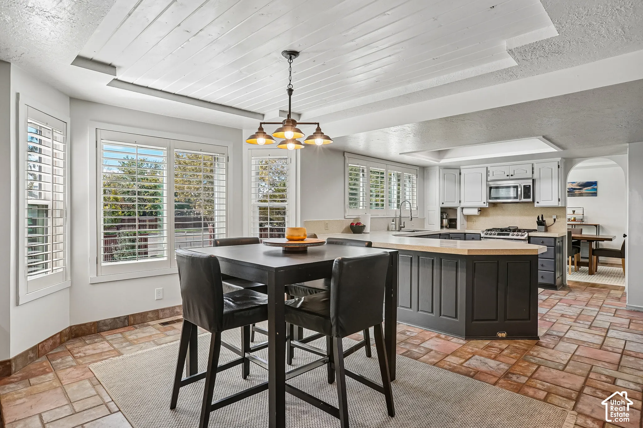 Kitchen featuring an island with wood-finish countertop, stainless steel appliances, and a gas range