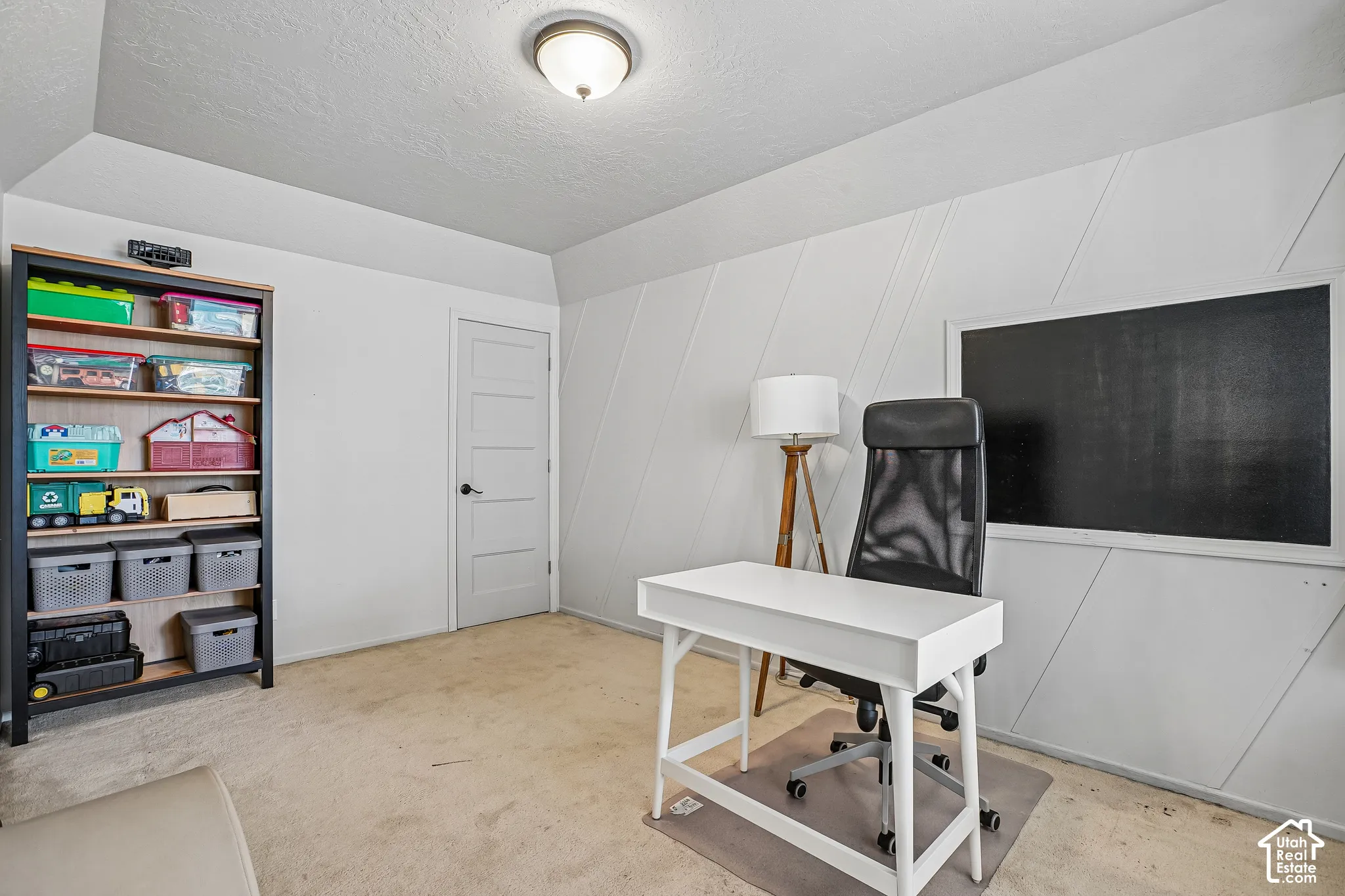 Recessed ceiling light fixture, textured ceiling, five-panel interior door, and wall paneling