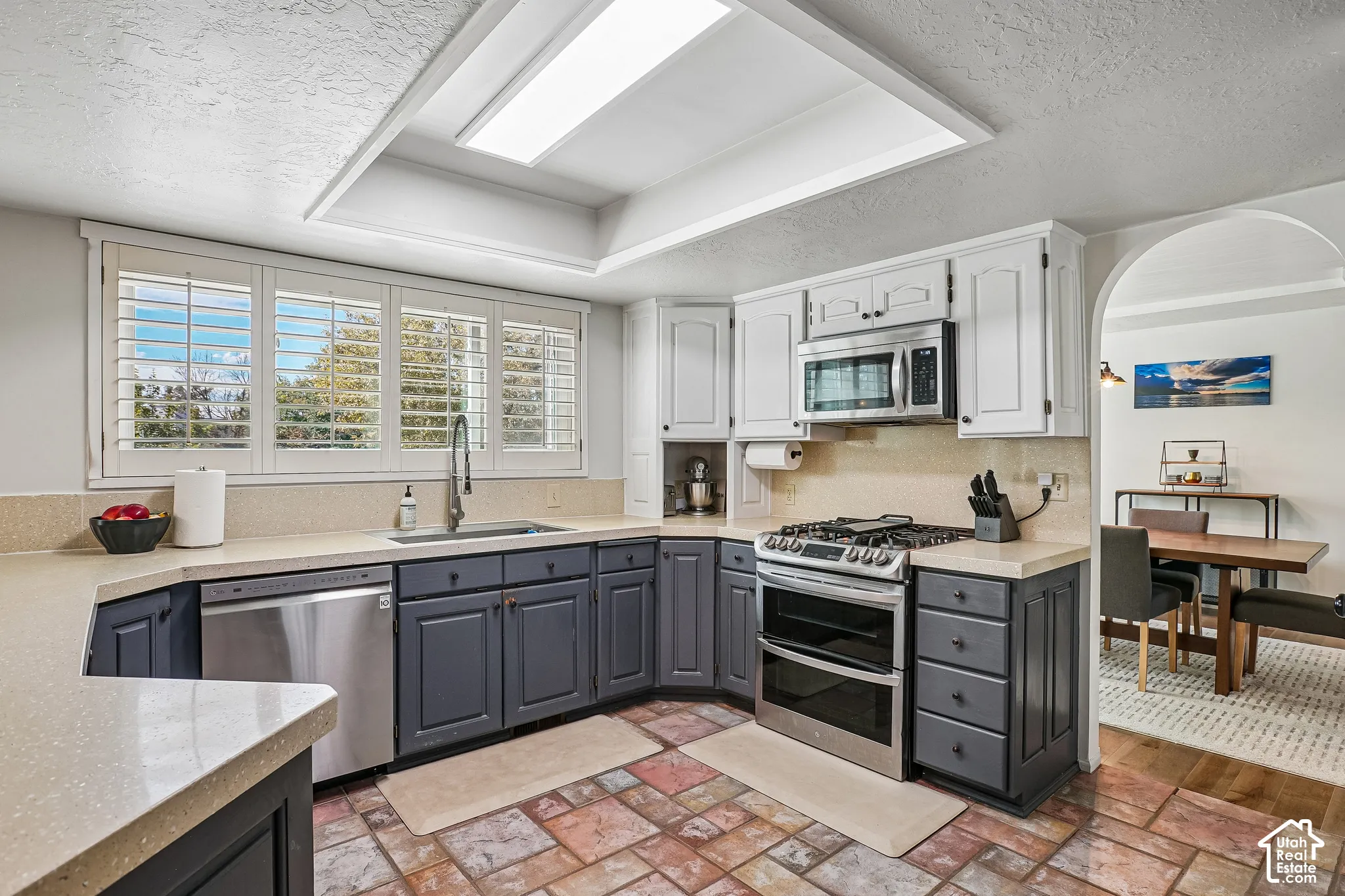 Kitchen featuring a stainless steel gas range, microwave, and dishwasher