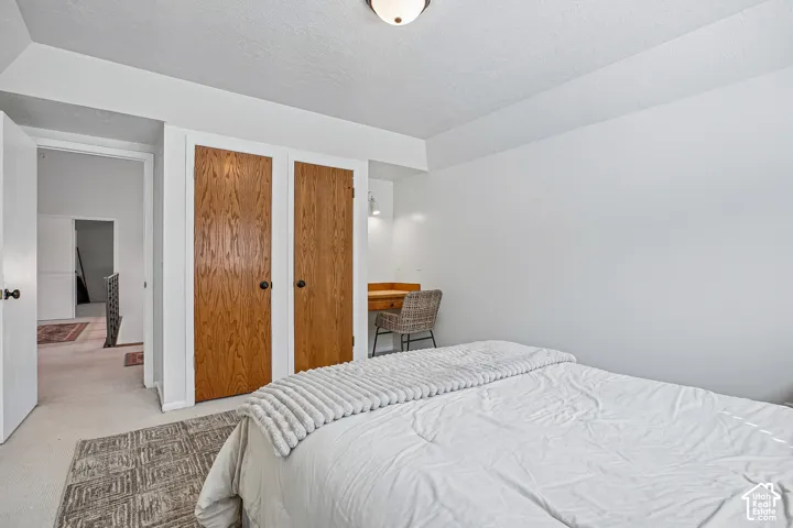 White walls throughout, wood-finish bi-fold closet doors, and recessed built-in desk area