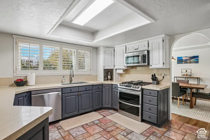 Kitchen featuring a stainless steel gas range, microwave, and dishwasher