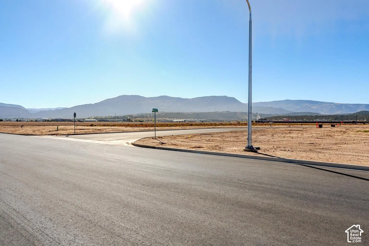 Paved street with a mountain backdrop