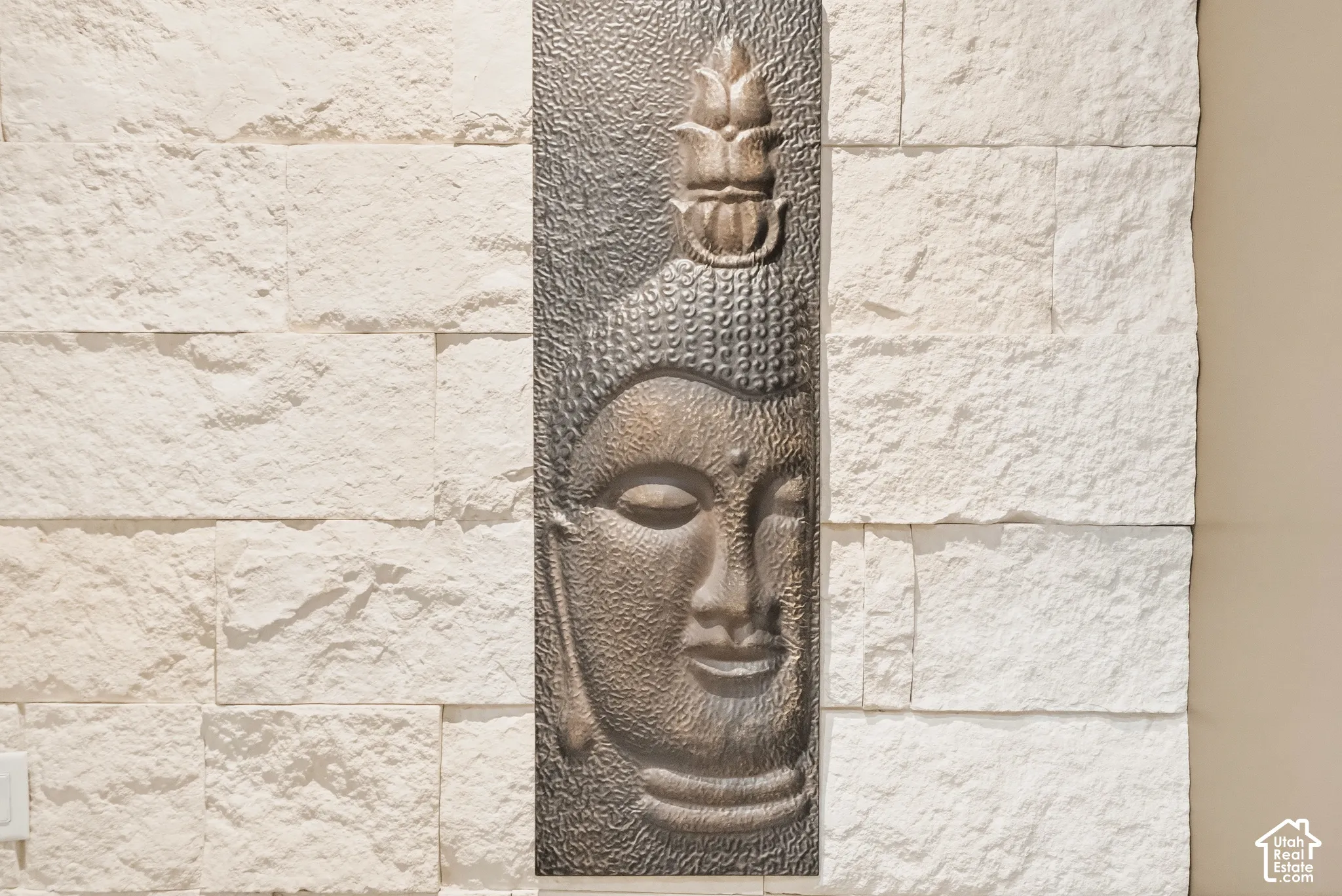Stacked stone accent wall with a rectangular decorative panel