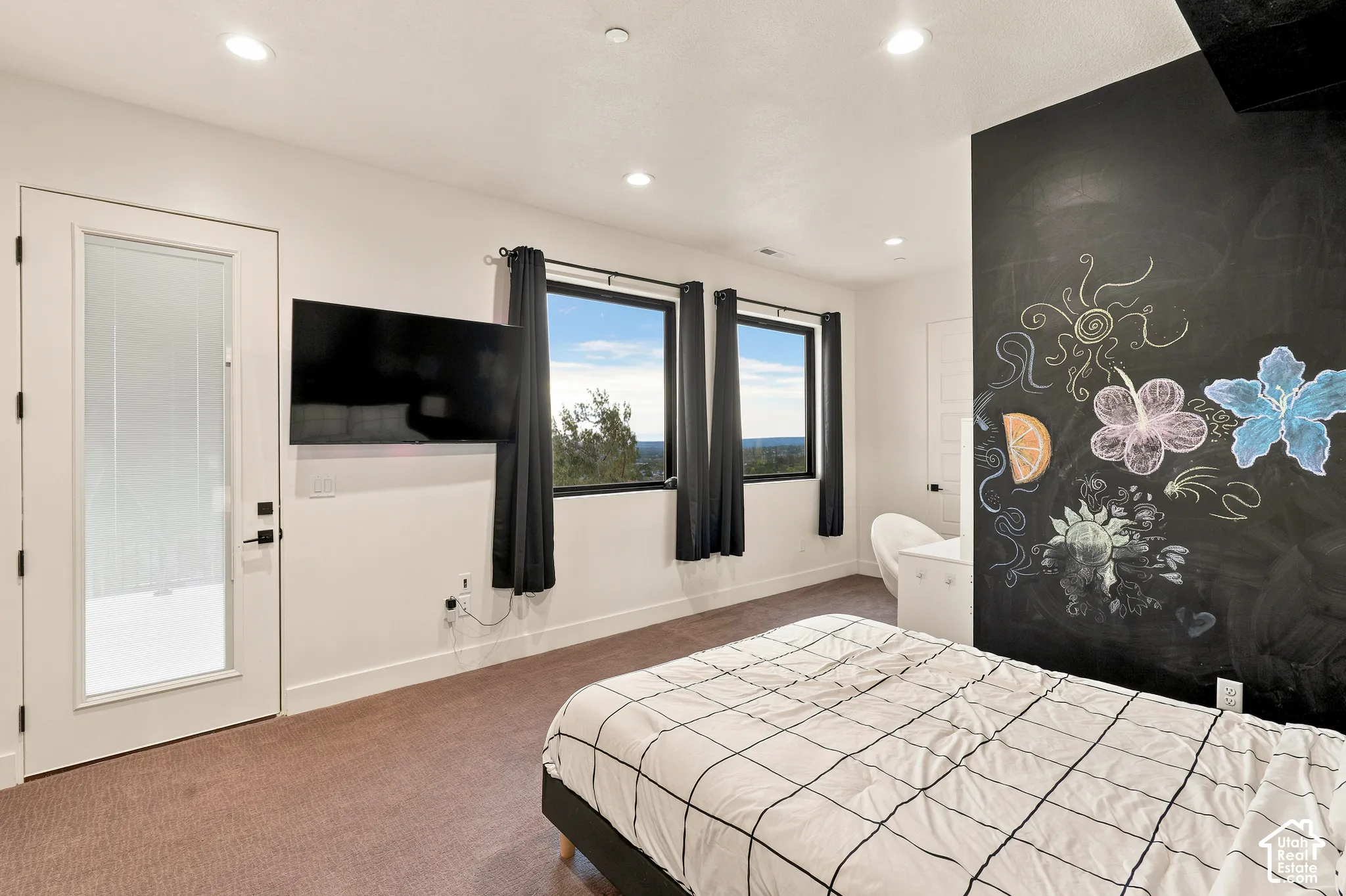 White interior walls, recessed lighting, and a full-light door with frosted glass