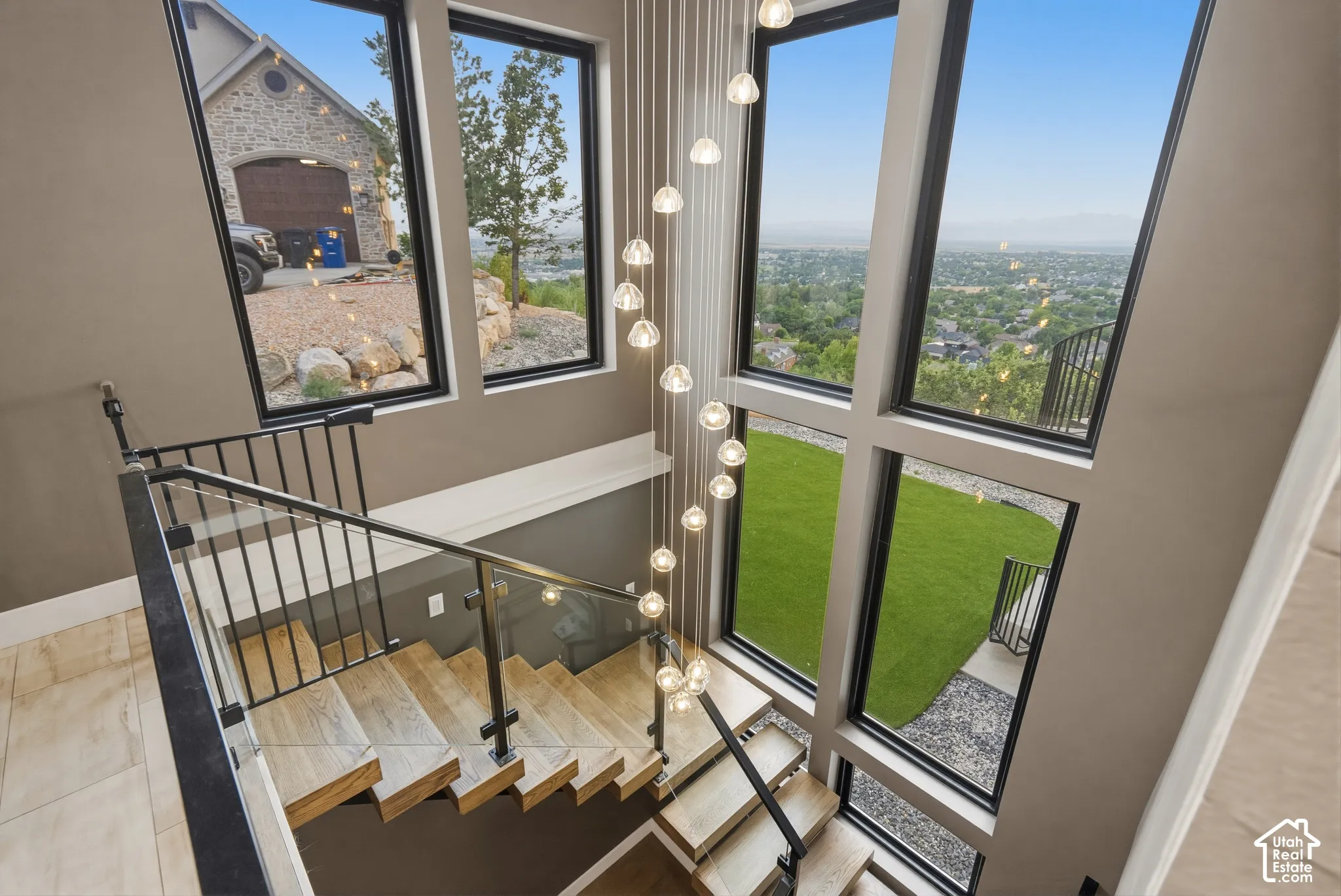 Multi-level staircase with wood-finish treads and glass panel railing