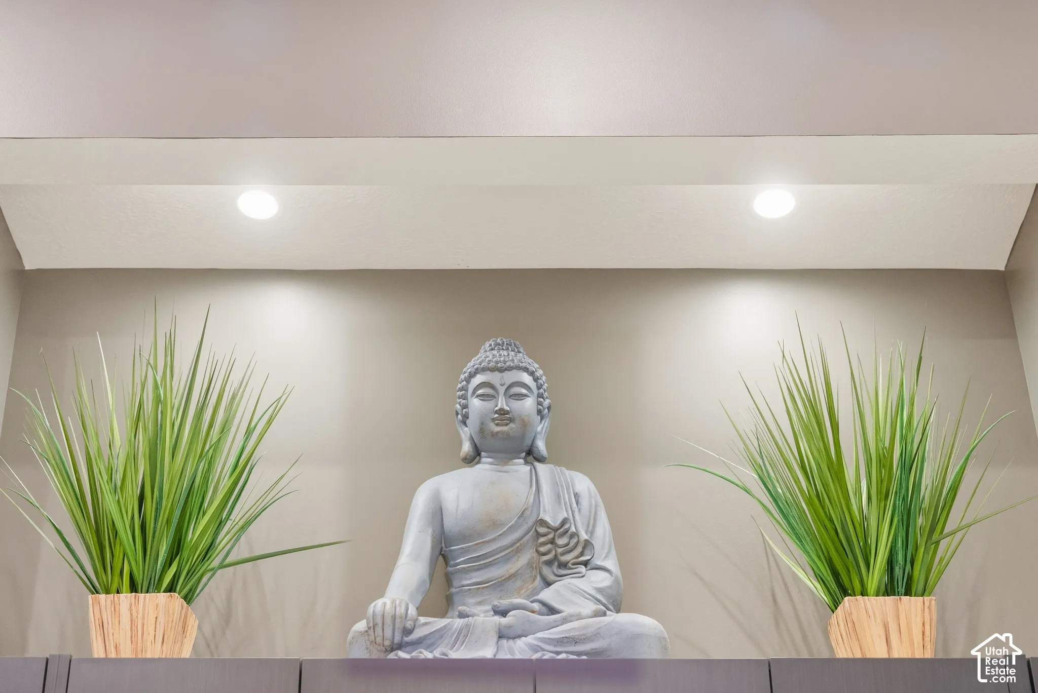 Recessed ceiling lighting illuminates a gray accent wall