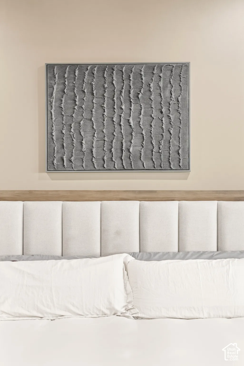Upholstered panel headboard with a wood-finish top trim