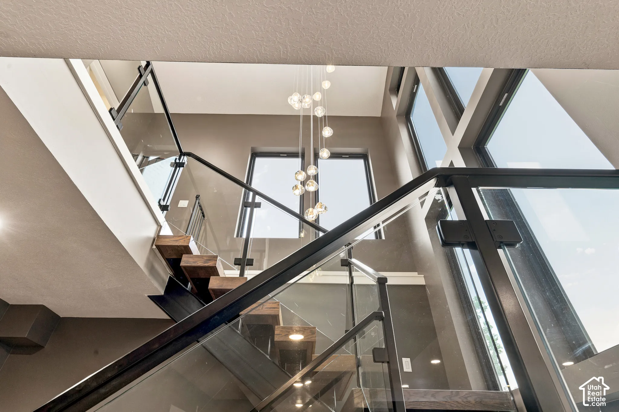 Floating wood treads with glass and black metal railing