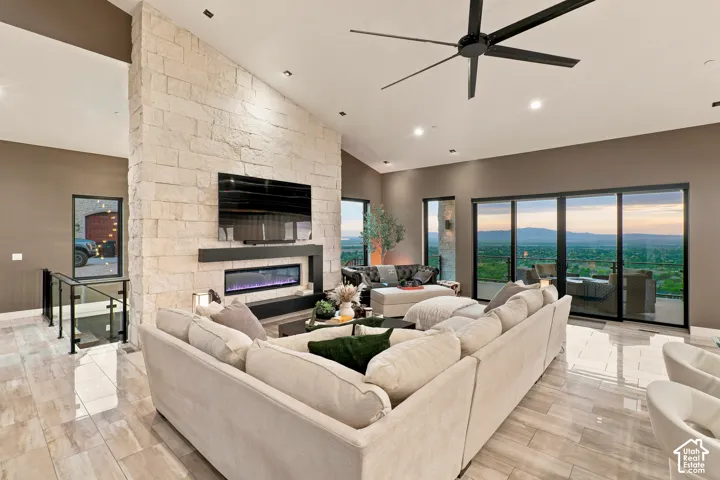 Vaulted ceiling with an impressive stone-clad fireplace and integrated media console
