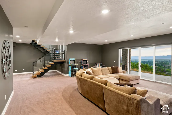 Spacious living area featuring carpet flooring, recessed lighting, and expansive sliding glass doors