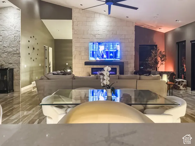 Vaulted ceilings enhance the main living area featuring a stacked stone fireplace with an integrated linear electric fireplace