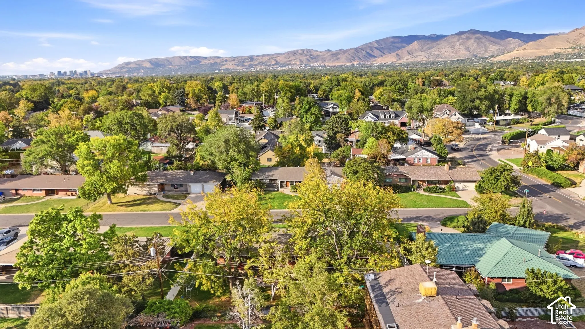 Leafy Millcreek neighborhood with the Salt Lake City skyline beyond.