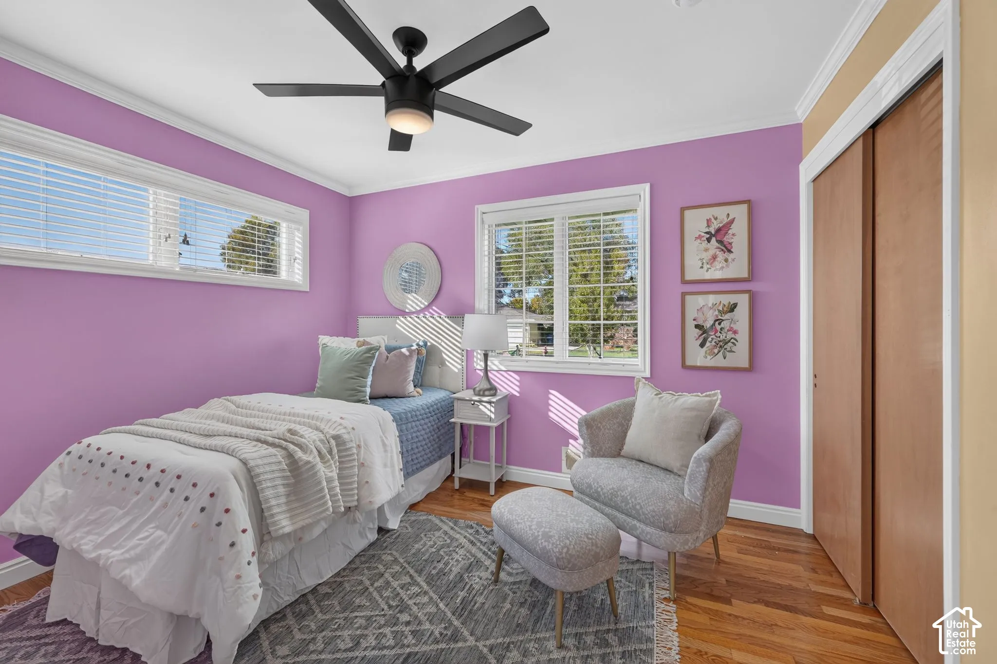Main-floor bedroom with a sliding-door closet and hardwood floors.