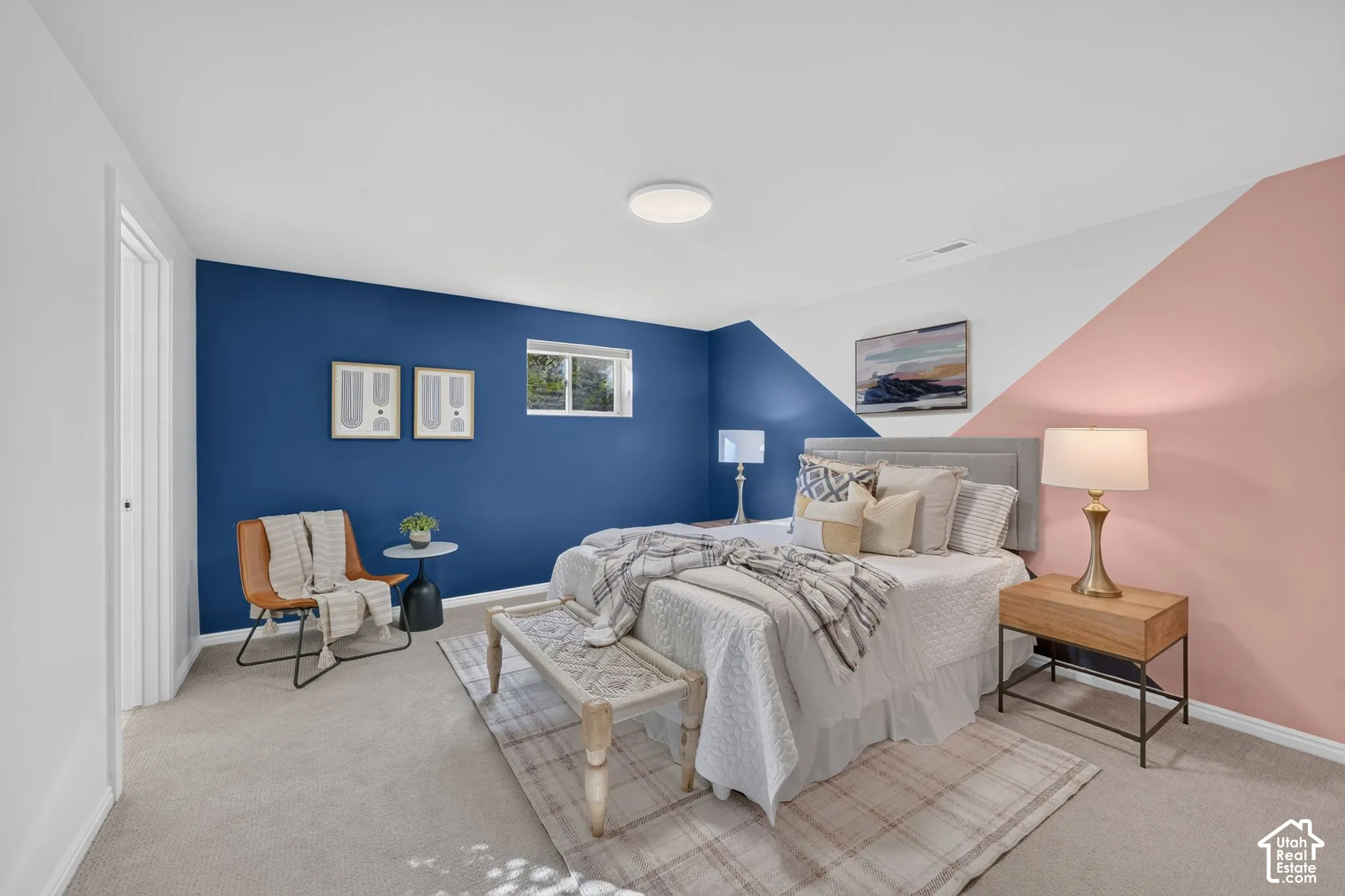 Lower-level bedroom with an egress window and color-block walls.