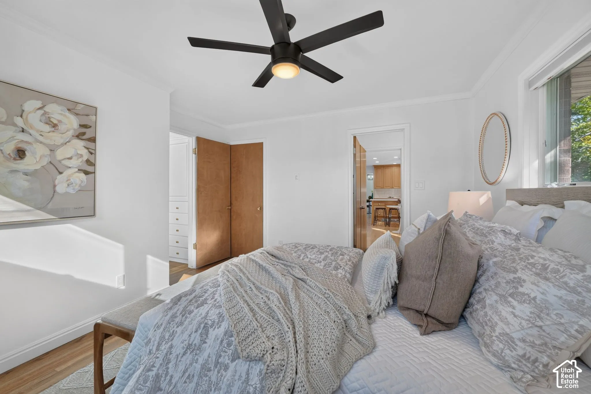 Primary bedroom with hardwood floors and a closet with built-in drawers.
