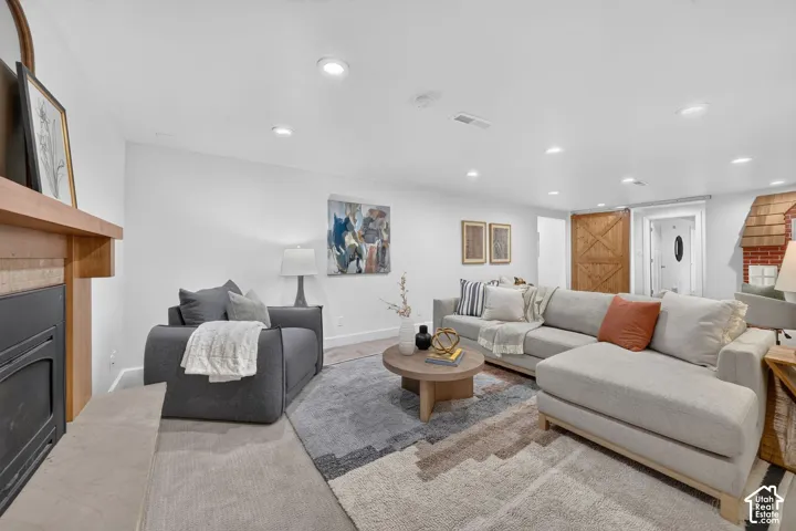 Lower family room with a gas fireplace, sliding barn door, and the built-in playhouse.