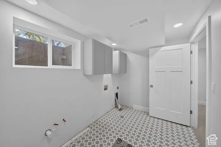 Gas and electric dryer hookups with storage.