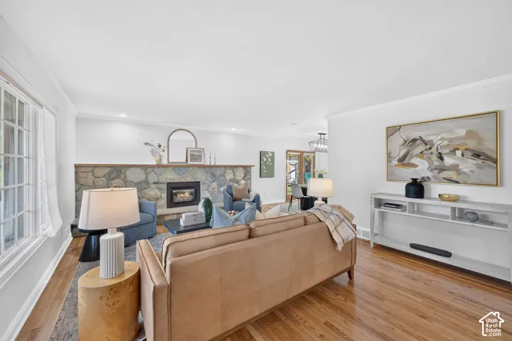 Living room with a stone gas fireplace and hardwood floors.