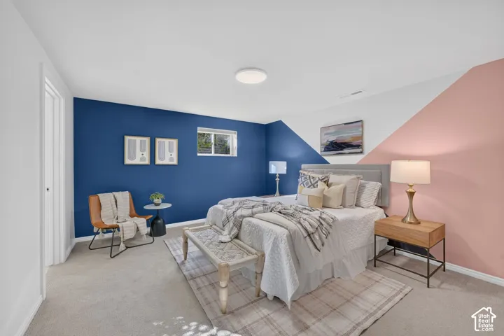 Lower-level bedroom with an egress window and color-block walls.
