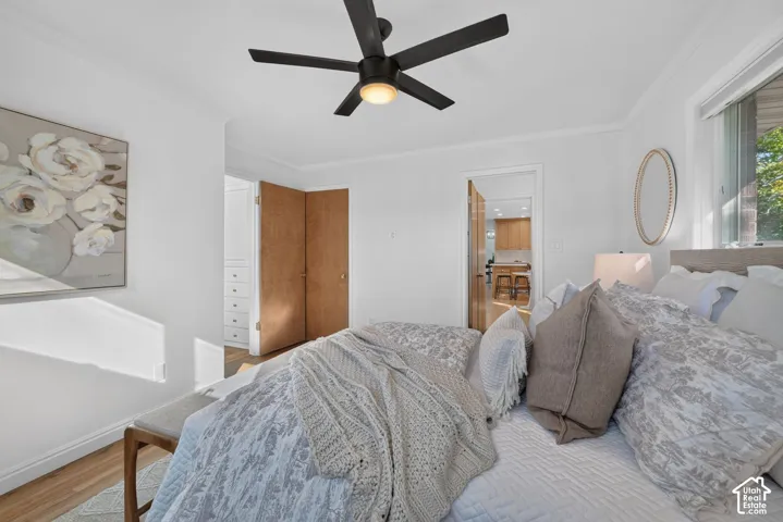 Primary bedroom with hardwood floors and a closet with built-in drawers.