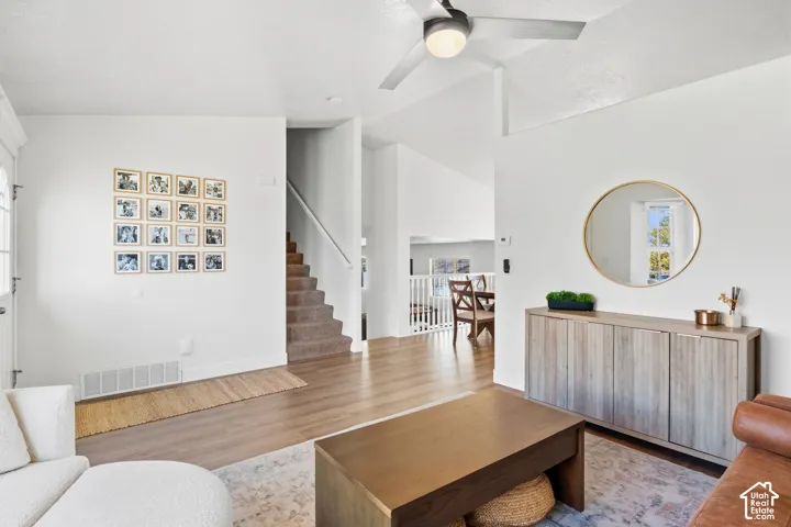 Wood-finish flooring, vaulted ceilings, and a modern ceiling fan