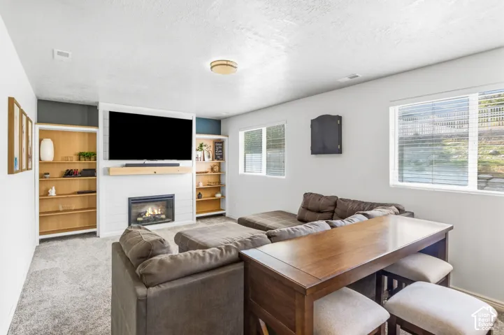 Fireplace with shiplap surround and wood mantel