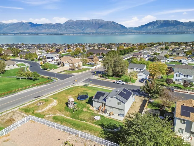 Aerial perspective showcasing a residential neighborhood with mountain and lake scenery