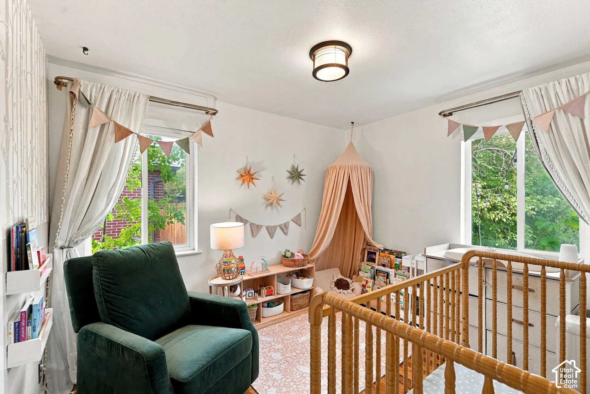Recessed lighting, two windows with drapery, and crown molding