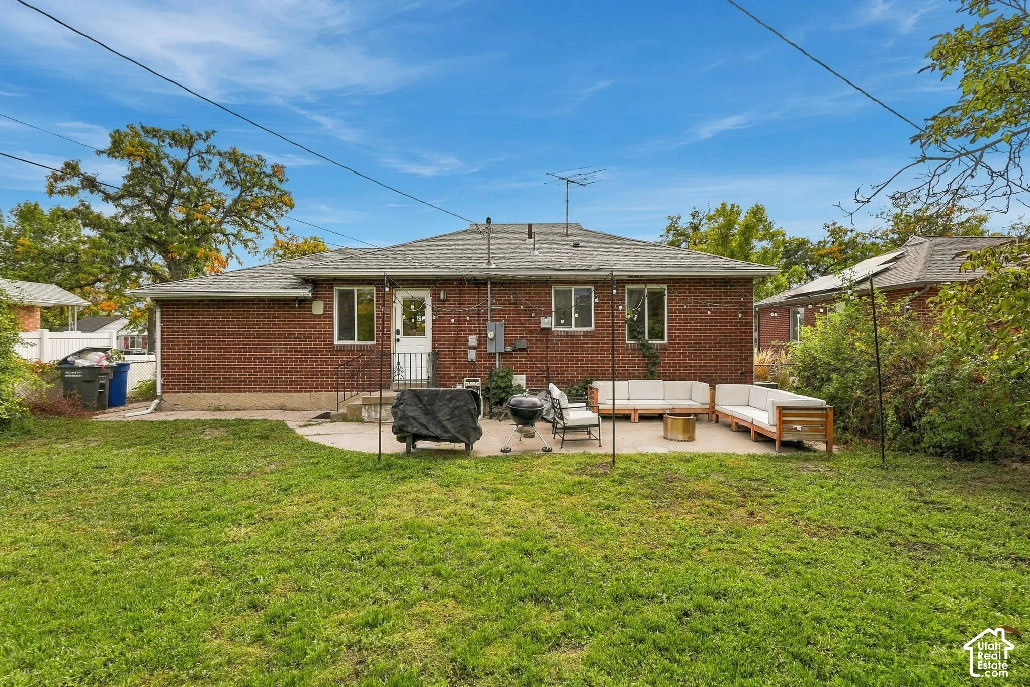 Red brick exterior with white trim windows and a rear entry door