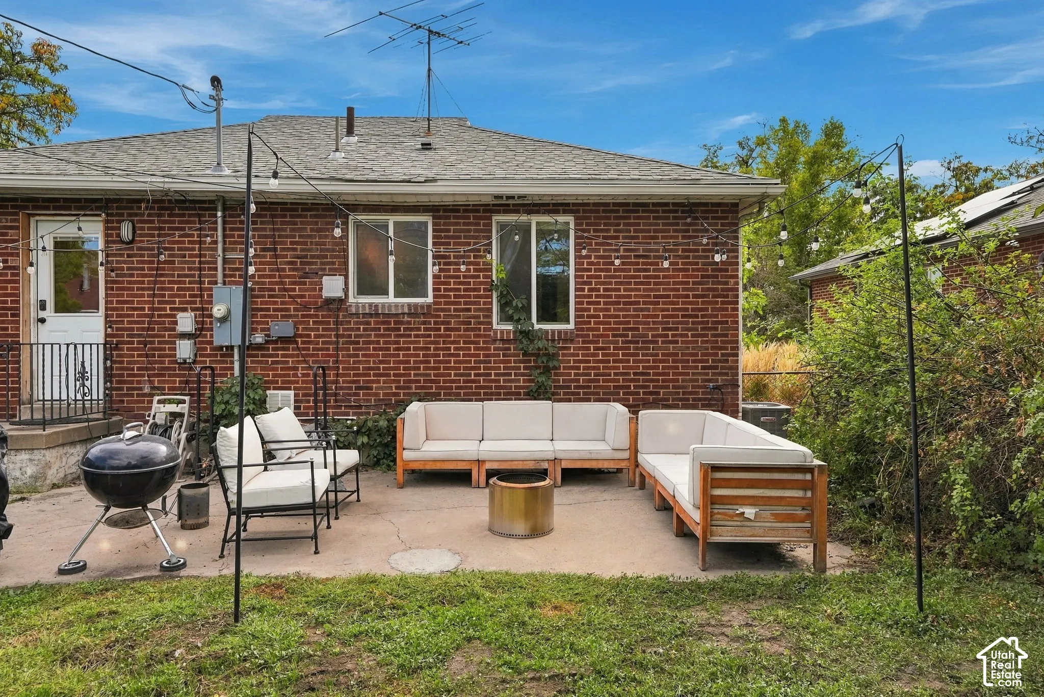 Brick exterior with mature landscaping and fenced yard