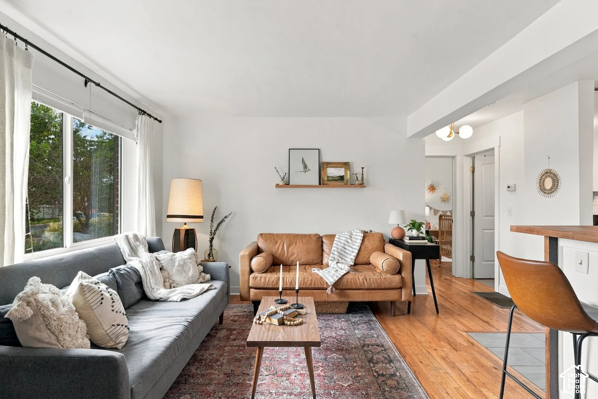 Hardwood flooring, abundant natural light, recessed lighting, white walls, and a built-in shelving unit