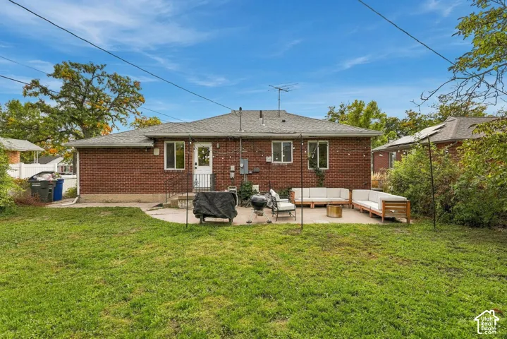 Red brick exterior with white trim windows and a rear entry door