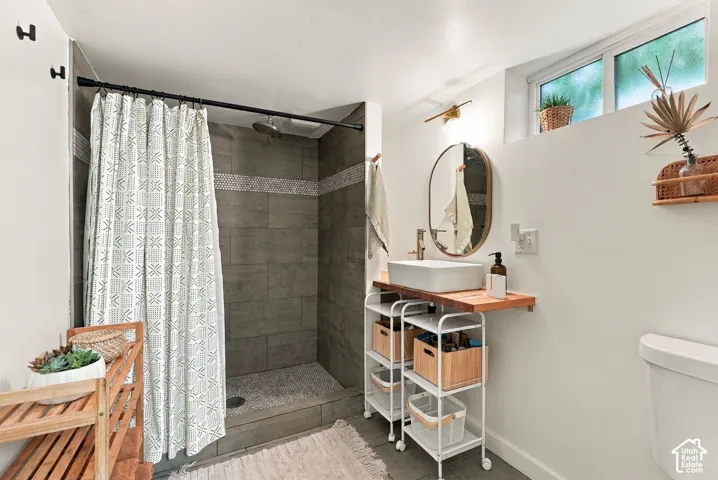 Walk-in shower with full-height tile surround and decorative accent band