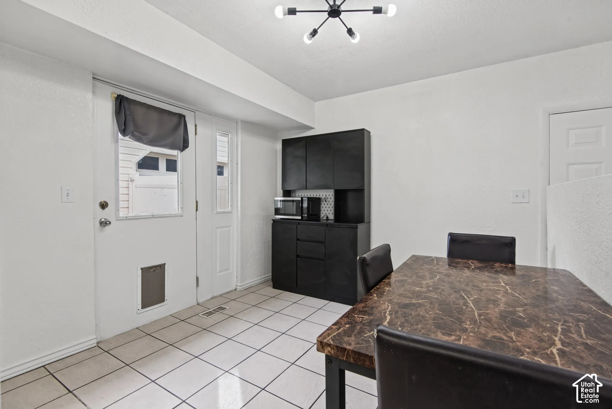 White tile flooring complemented by a black built-in cabinet