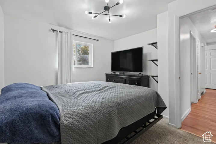 Recessed window with white trim, modern black chandelier, and built-in shelving units