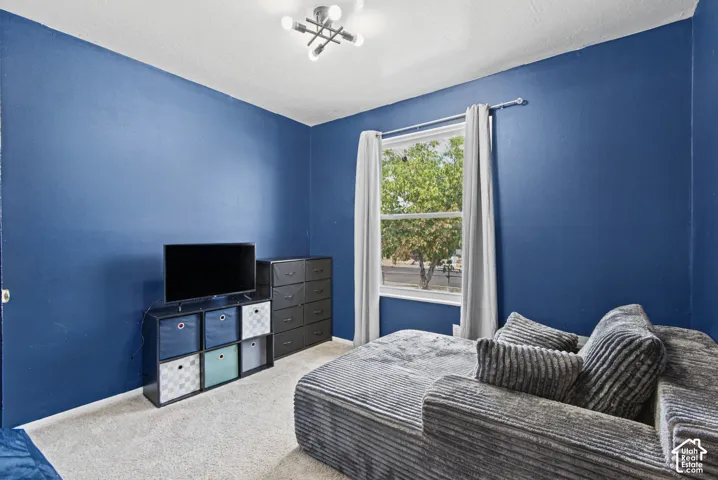Recessed window with white trim, contemporary ceiling light fixture, and light-toned carpeting