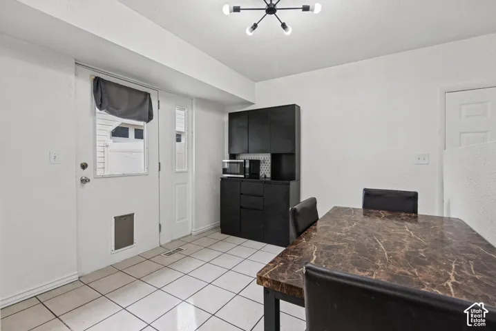White tile flooring complemented by a black built-in cabinet