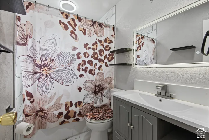 Vanity with integrated sink, wall-mounted mirror, and floating wall shelves