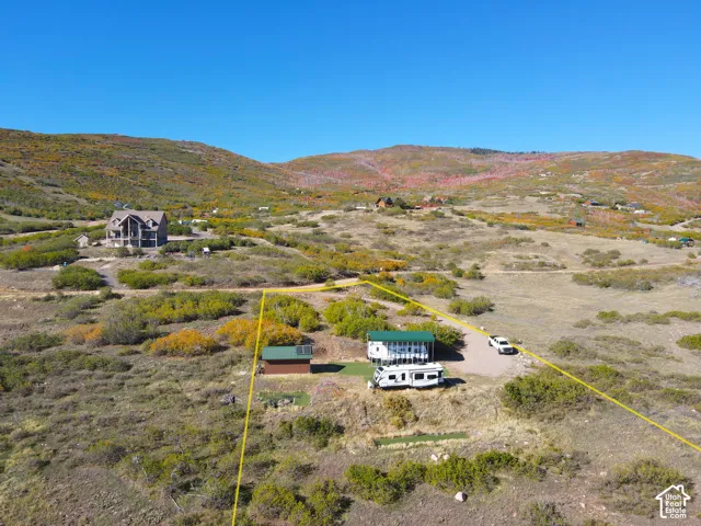 Expansive land featuring a visible property boundary and surrounding natural landscape