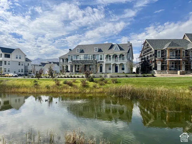 Waterfront setting with a manicured lawn and mature landscaping