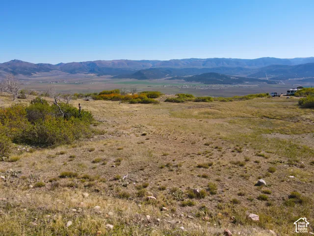 Expansive undeveloped land featuring a natural landscape and distant mountain ranges