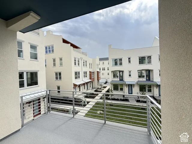 Balcony with sleek metal railings and textured flooring