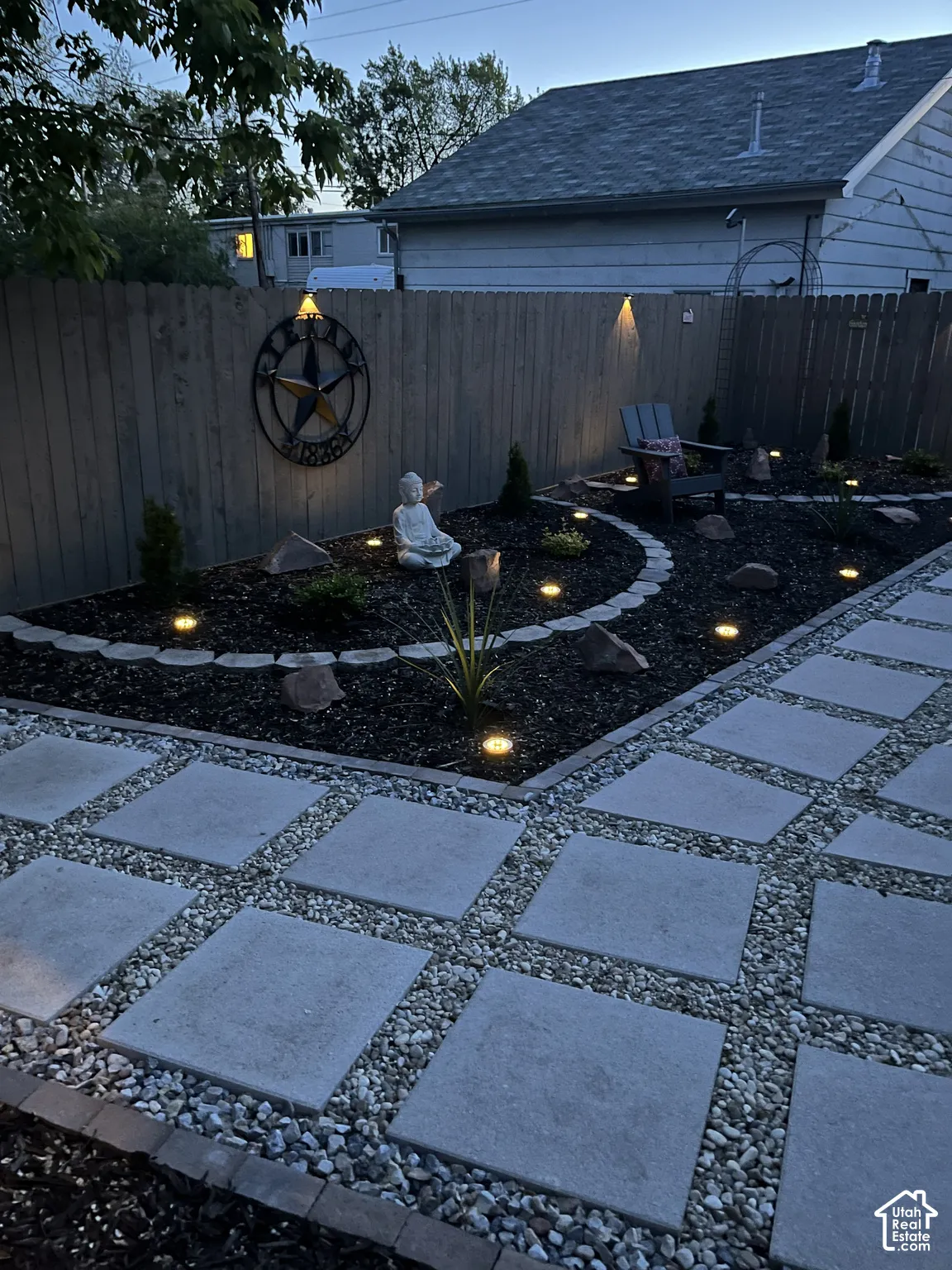 Paved patio path with square stepping stones and gravel infill, featuring integrated ground lighting
