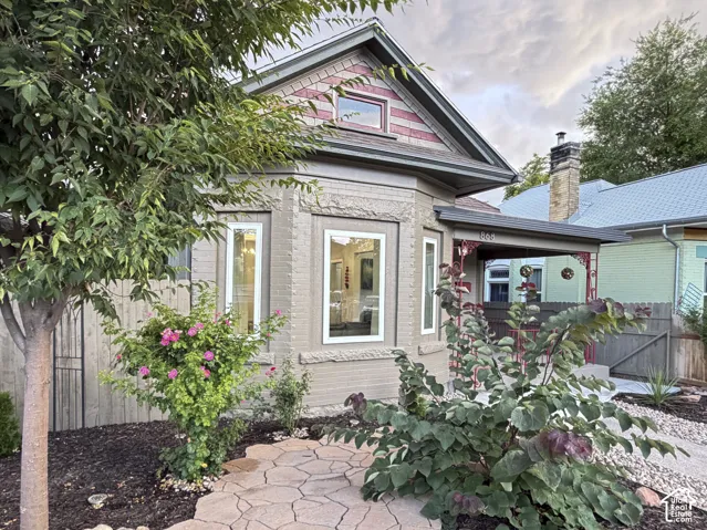 Brick exterior with bay windows, covered porch, and gabled roofline.