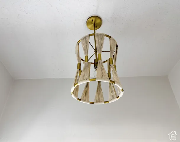 Decorative ceiling light fixture with a brass-finish frame and rope-wrapped accents