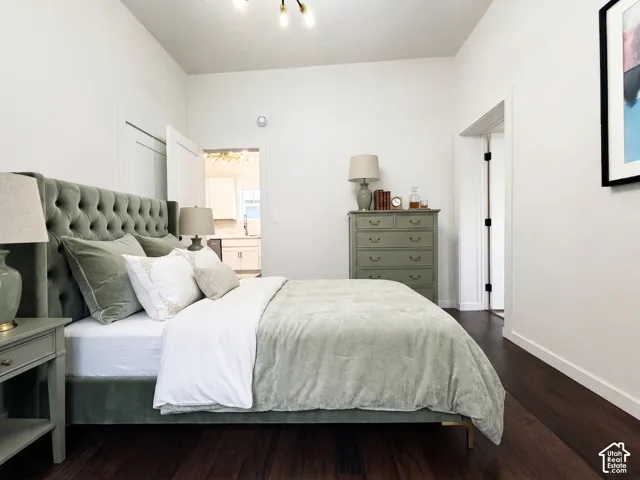 Dark wood-finish flooring with white baseboards