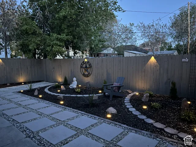 Patio area featuring square pavers with gravel accents and solar lights.