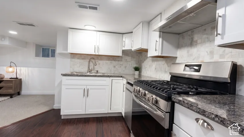 Second full kitchen features granite countertops, stainless steel appliances, and a tiled backsplash