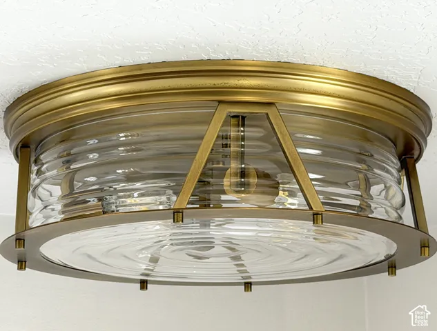 Brass-finish flush mount light fixture with clear ribbed glass and clear rippled glass base